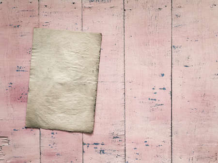 old paper on grunge pink wooden backgroundの写真素材