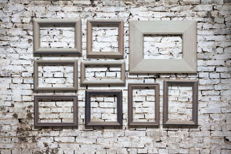 old photo frames on brick wallの写真素材