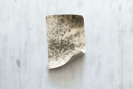 old paper on blue wooden wall, retro backgroundの写真素材