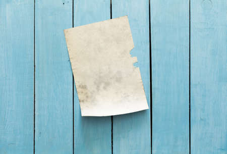 old paper on blue wooden wall, retro backgroundの写真素材