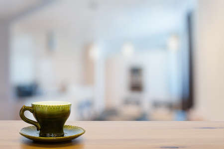 old green vintage cup on wooden table in the living roomの写真素材