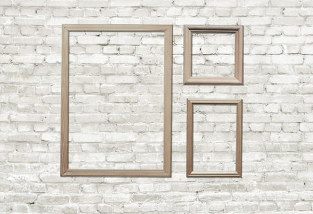 old photo frames on brick wall