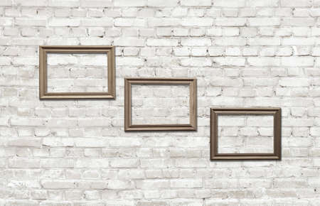 old photo frames on brick wallの写真素材