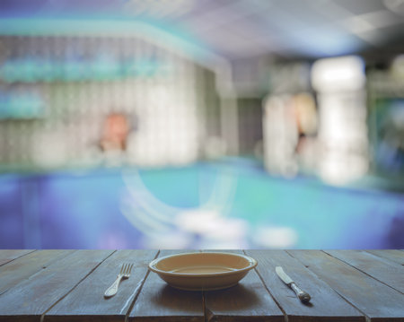 empty plate with fork and knife on wooden table in the club
