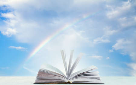 book on wooden table and sky backgroundの写真素材