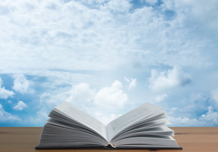 book on wooden table and sky background