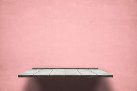 empty shelf on pink wooden wallの写真素材