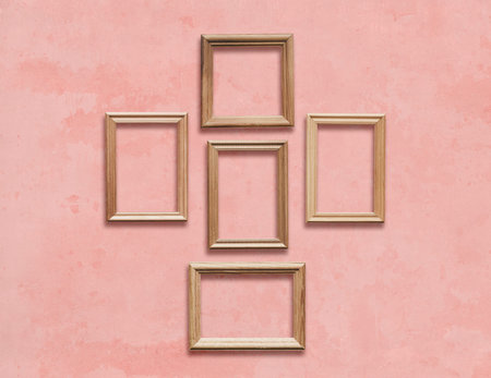 old wooden frames on pink wall