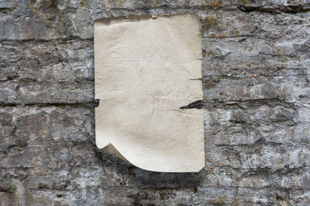 old paper on stone wallの写真素材