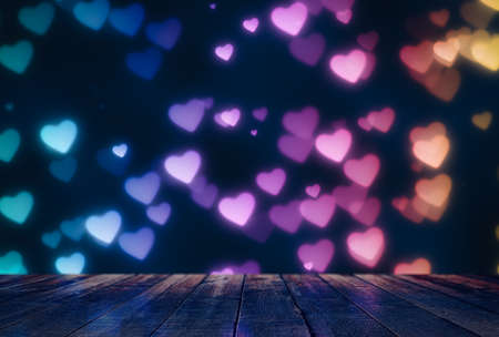 Empty wooden table over heart shape bokeh, bright Valentine's day background.の写真素材
