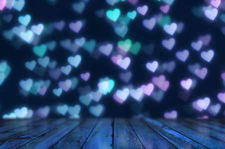 Empty wooden table over heart shape bokeh, bright Valentine's day background.の写真素材