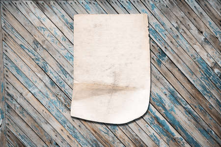 white paper on old wooden wall, background with copy spaceの写真素材