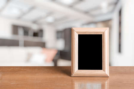 photo frames on the wooden table in the living roomの写真素材