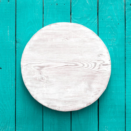 grunge empty round wooden plate on old wooden table, background with copyspaceの写真素材