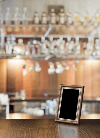 old photo frame on the wooden table in a night clubの写真素材
