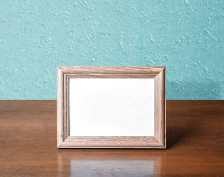 wooden photo frame on table, blue wall