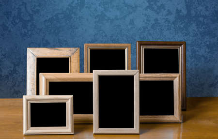 wooden photo frames on table, blue wallの写真素材