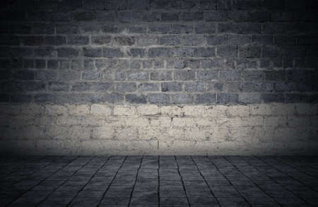 Empty room with bricks wall and tiled floor. Dark background.の写真素材