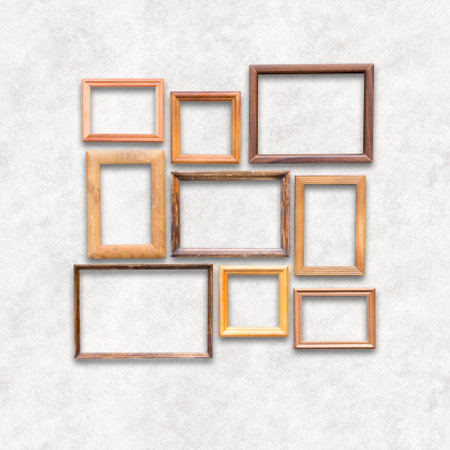 wooden photo frames on white wallの写真素材