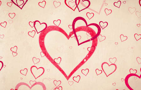 Valentine's day vintage background with hearts on old paper textureの写真素材