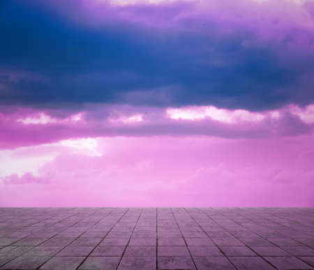 pink clouds, blue sky, gray floor. neon dramatic background.の写真素材
