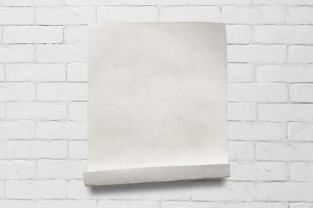 old paper on white brick wall