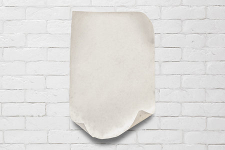 old paper on white brick wall