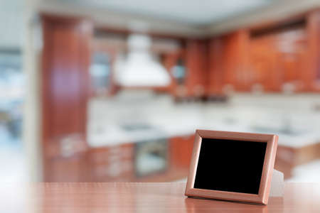 photo frame on the wooden table in the kitchenの写真素材