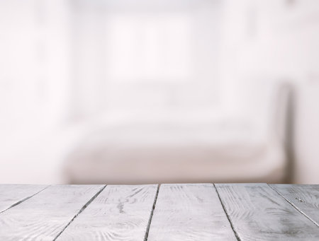 white wooden table in the room with big windowsの写真素材