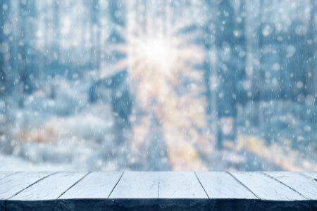 Old frozen wooden table and snowy forest. Christmas and new year winter background.の写真素材