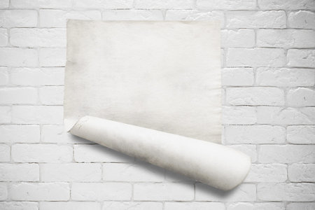 old paper on white brick wall
