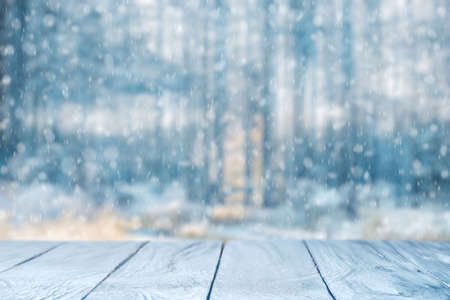 Old frozen wooden table and snowy forest. Christmas and new year winter background.の写真素材