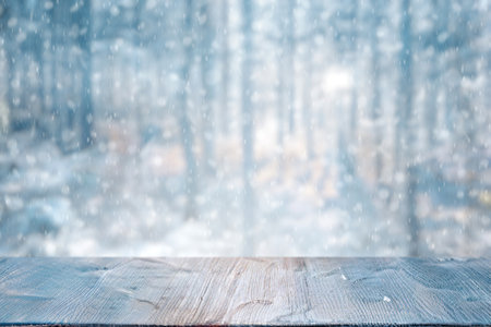 Old frozen wooden table and snowy forest. Christmas and new year winter background.の写真素材
