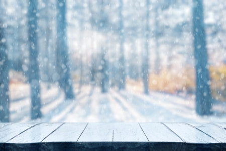 Old frozen wooden table and snowy forest. Christmas and new year winter background.の写真素材