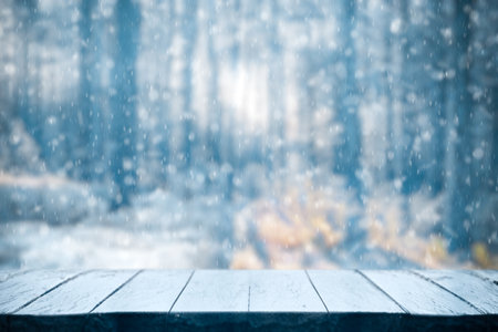 Old frozen wooden table and snowy forest. Christmas and new year winter background.の写真素材