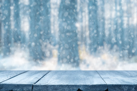 Old frozen wooden table and snowy forest. Christmas and new year winter background.の写真素材