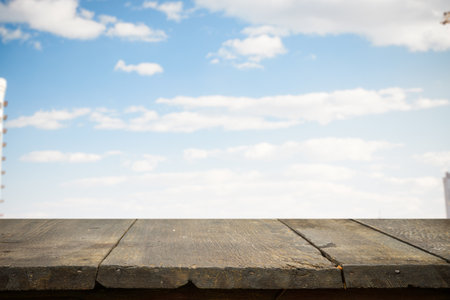 brown wooden table, beautiful blue sky. background.の写真素材