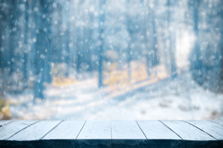 Old frozen wooden table and snowy forest. Christmas and new year winter background.の写真素材