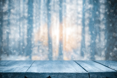 Old frozen wooden table and snowy forest. Christmas and new year winter background.の写真素材