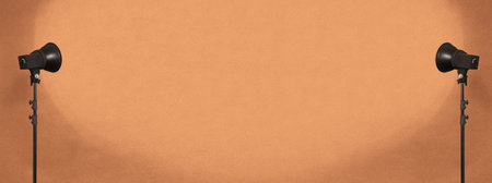 lighting studio equipment, color concrete background, orange plaster wall, banner sizeの写真素材