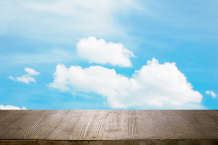 brown wooden table, beautiful blue sky. background.の写真素材