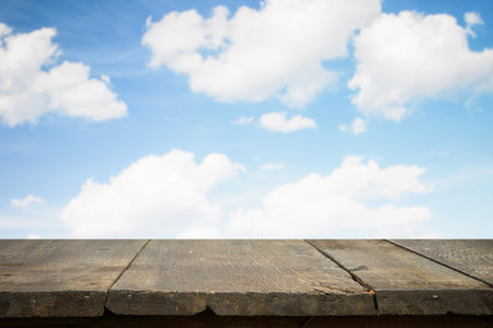 brown wooden table, beautiful blue sky. background.の写真素材