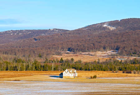 Typical farmhouse in West Virginia  A lonely farmhouse on a sunny winter day with forestry hills in the background のeditorial素材