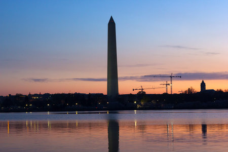 Washington Monument at dawn with city skyline on background  Colorful reflections in Tidal Basin...