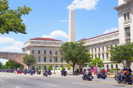 WASHINGTON, DC, USA - MAY 25, 2014: Memorial Day weekend motorbikes rally on Independence Avenue with National Monument in a view. Annual Rolling Thunder motorcycle ride for American POWs and MIA soldiers on May 25, 2014 in Washington, DC, USAのeditorial素材