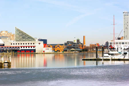 Baltimore Inner Harbor in winter. Buildings reflections in icy waters.の写真素材