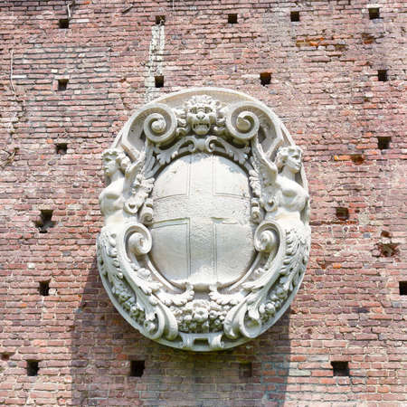 Coat of arms bas-relief on the wall of Sforza castle in Milan, Italy. Ancient restored coat of arms bas-relief on the wall of castle.のeditorial素材