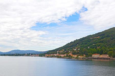 Country town on Lake Como shore in Northern Italy. Panoramic view of the lake and harbor villas during sunset hours.の写真素材