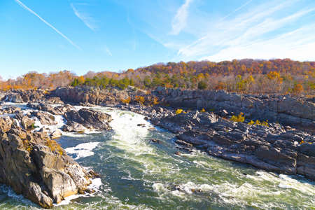 Great Falls National Park in autumn, Virginia USA. Potomac river with rocky banks and colorful autumn trees.の写真素材