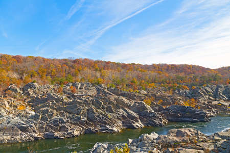 Great Falls National Park in autumn, Virginia USA. Potomac river fringed by rocky banks and colorful autumn trees.の写真素材